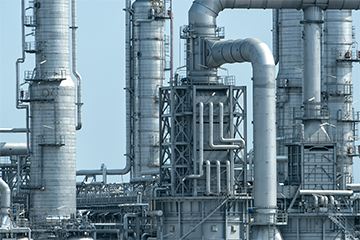 A close up shot of metal tubes and cylinders on an oil and gas site