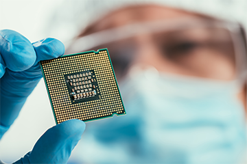 Selective focus of engineer holding computer microchip